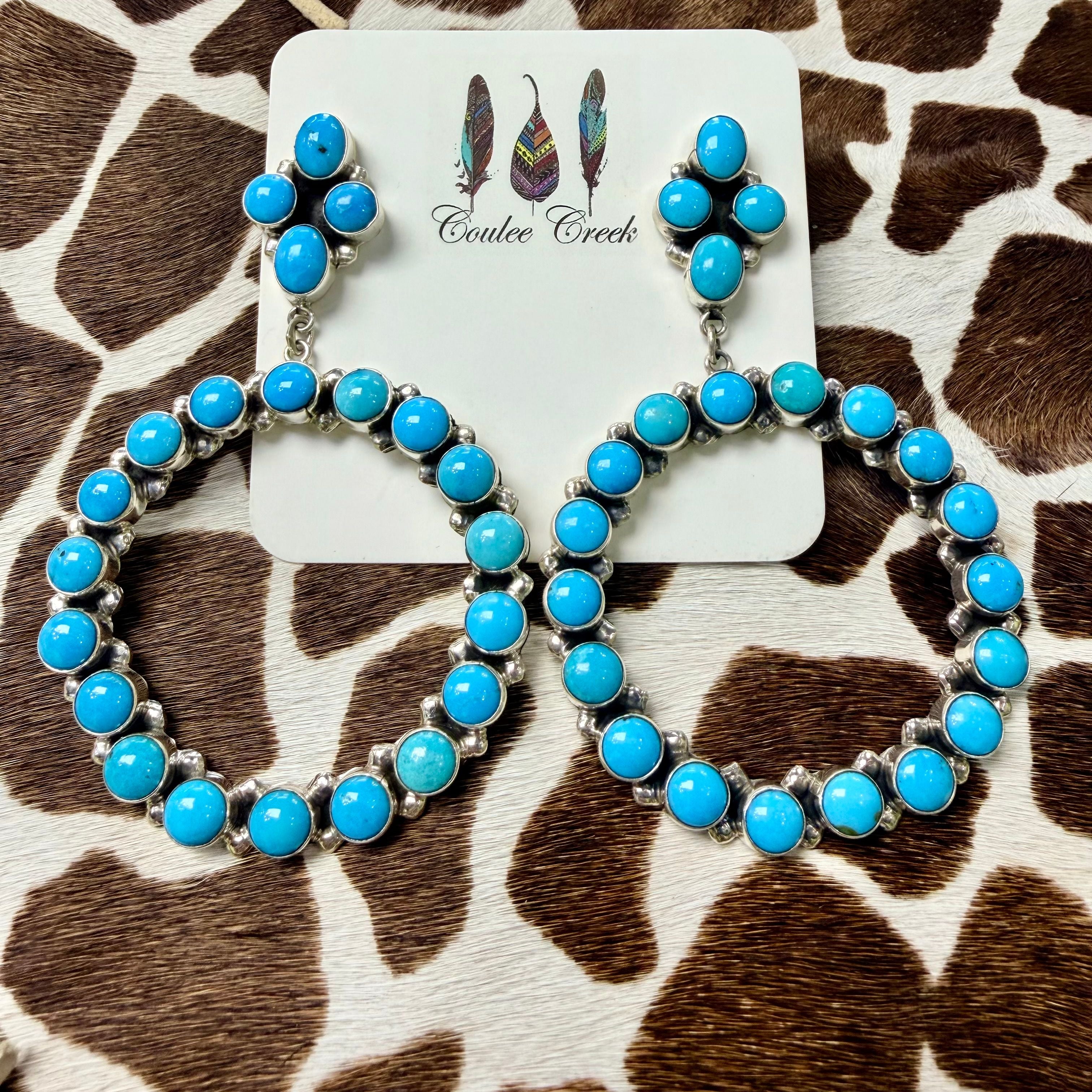 Turquoise and silver squash blossom earrings with cluster stone design on a Coulee Creek branded card