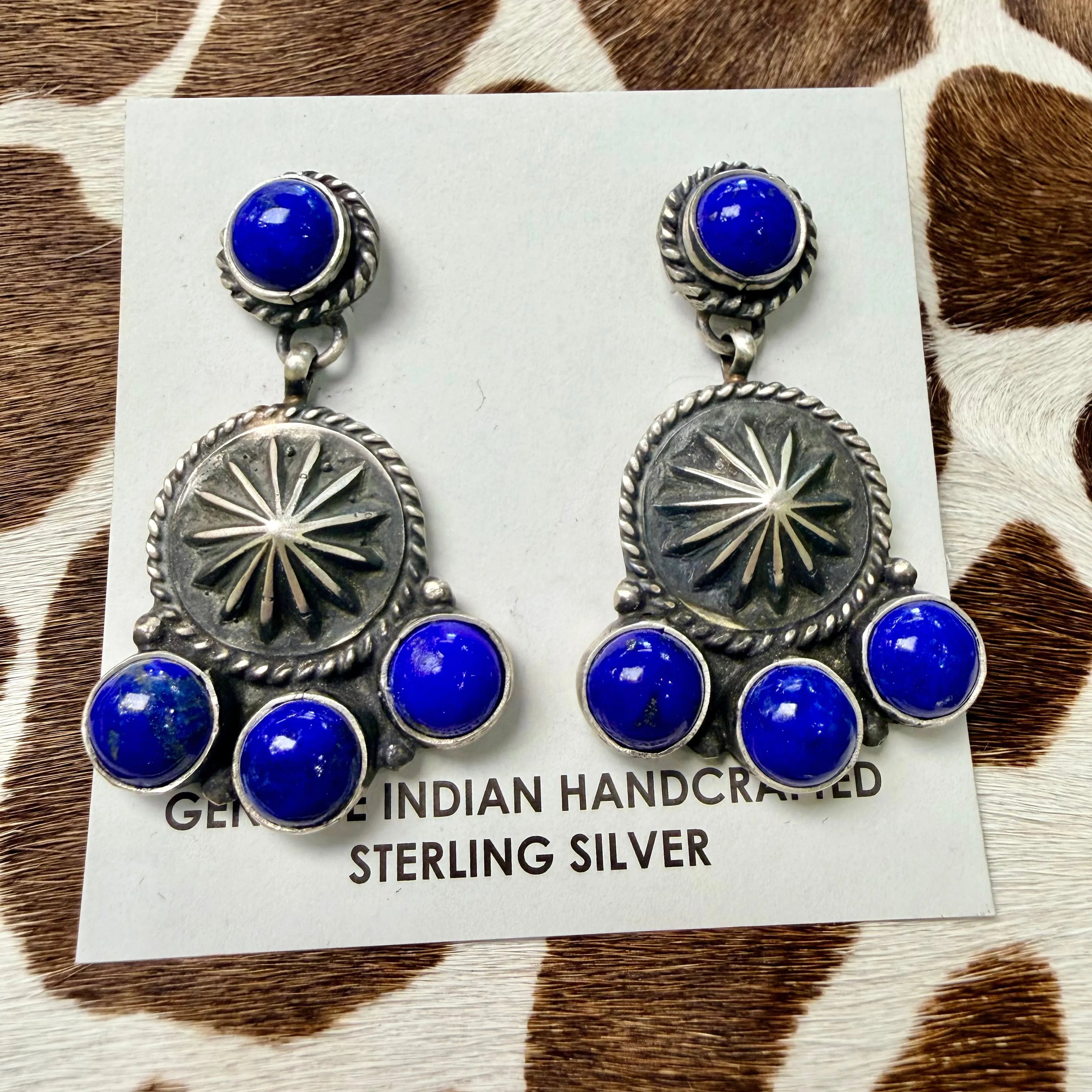 Lapis lazuli and sterling silver concho dangle earrings with sunburst stampwork design on a Genuine Indian Handcrafted Sterling Silver card