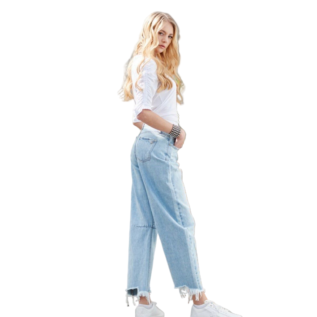 Woman wearing a casual white top with light wash wide-leg jeans and studded western bracelet