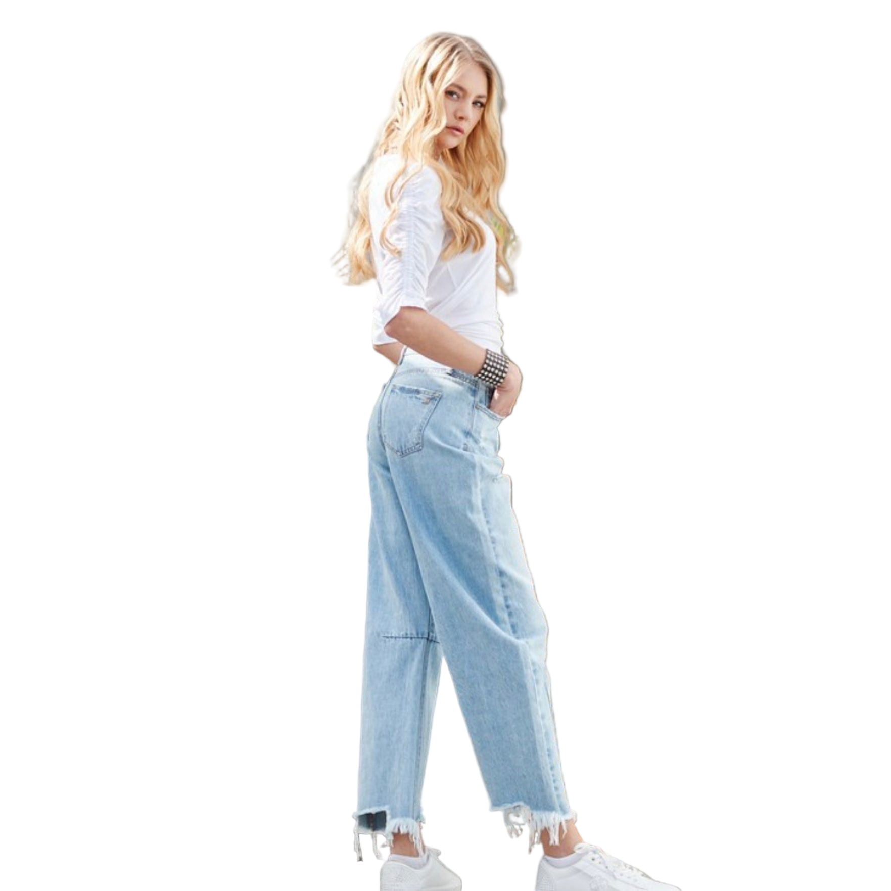Woman wearing a casual white top with light wash wide-leg jeans and studded western bracelet