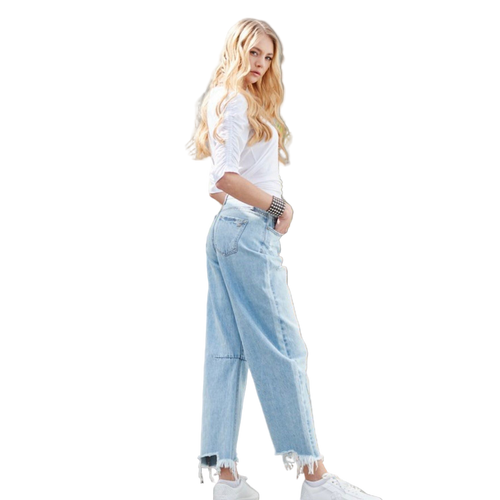 Woman wearing a casual white top with light wash wide-leg jeans and studded western bracelet