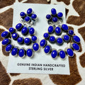 Blue lapis lazuli and sterling silver oval stud earrings displayed on a Genuine Indian Handcrafted Sterling Silver card