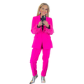 Woman in a hot pink suit with feathered cuffs, silver metallic boots, and statement earrings